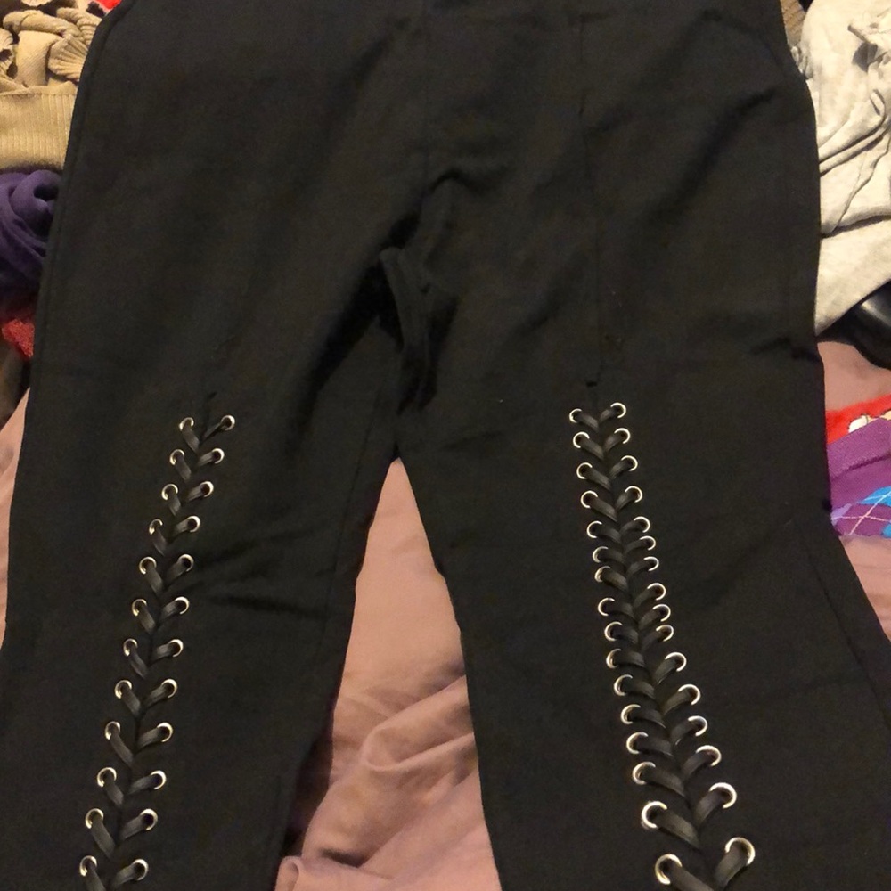 Laced black pants fashion to figure
